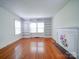 Bright living room featuring hardwood floors, fireplace, and built-in shelves at 705 Neil St, Gastonia, NC 28052