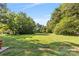A large, manicured lawn surrounded by mature trees creates a picturesque backyard setting at 640 Davie Ave, Statesville, NC 28677
