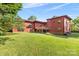 Spacious backyard with lush lawn and wooded surroundings offers a serene outdoor retreat at 640 Davie Ave, Statesville, NC 28677