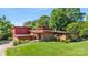 Beautifully landscaped modern home featuring red wood, brick accents, and a lush green lawn at 640 Davie Ave, Statesville, NC 28677