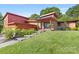 Inviting home with red wood and brick exterior, mature landscaping, and stepped pathway to the front door at 640 Davie Ave, Statesville, NC 28677