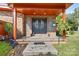 Charming front porch with brick accents, double doors with round glass, and potted plants at 640 Davie Ave, Statesville, NC 28677
