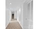 The hallway is clean with neutral carpet, white walls, and recessed lighting at 640 Davie Ave, Statesville, NC 28677