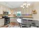 Well-lit kitchen with stainless steel appliances, granite countertops and white cabinetry at 640 Davie Ave, Statesville, NC 28677