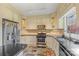 Well-equipped kitchen features cream cabinets, stainless steel appliances, and ample counter space at 640 Davie Ave, Statesville, NC 28677