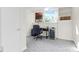 This office features neutral carpet, shelving, a window, and desk with a rolling chair at 640 Davie Ave, Statesville, NC 28677