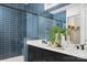 Stylish bathroom with dual vanities, a glass-enclosed shower with blue tiling, and modern fixtures at 5209 Mint Harbor Way # 0352, Charlotte, NC 28269