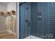 Modern bathroom with a glass-enclosed shower featuring striking blue tile and spa-like decor at 5209 Mint Harbor Way # 0352, Charlotte, NC 28269