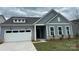 Charming one-story home featuring a two-car garage and welcoming front porch at 5209 Mint Harbor Way # 0352, Charlotte, NC 28269