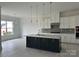 Bright kitchen featuring a large island, stainless steel appliances, and sleek white cabinetry at 5209 Mint Harbor Way # 0352, Charlotte, NC 28269