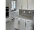 Well-lit kitchen with updated stainless appliances, white cabinets, and stylish backsplash at 5209 Mint Harbor Way # 0352, Charlotte, NC 28269