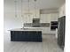 Modern kitchen featuring a large island, stainless steel appliances, and sleek white cabinetry at 5209 Mint Harbor Way # 0352, Charlotte, NC 28269