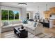 Open-concept living room showcasing a large sectional sofa, natural light, and views of the kitchen and backyard at 5209 Mint Harbor Way # 0352, Charlotte, NC 28269