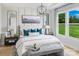 Serene main bedroom with a large window, accent wall, and elegant furnishings at 5209 Mint Harbor Way # 0352, Charlotte, NC 28269