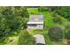 Aerial view of a house with detached workshop and solar panels, nestled in a wooded area at 7507 Waxhaw Creek Rd, Waxhaw, NC 28173