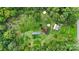Aerial showing a house, yard, and solar panels on a wooded lot at 7507 Waxhaw Creek Rd, Waxhaw, NC 28173