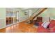 Cozy living room features hardwood floors, a fireplace, and access to a sunroom at 7507 Waxhaw Creek Rd, Waxhaw, NC 28173