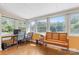 Bright sunroom with wood floors, workspace, and bench seating at 7507 Waxhaw Creek Rd, Waxhaw, NC 28173