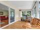 Sunroom features wood floors, built-in workspace, and bench at 7507 Waxhaw Creek Rd, Waxhaw, NC 28173
