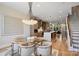 Open concept dining area with modern chandelier and kitchen view at 112 Frazier Ave, Charlotte, NC 28216