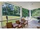 Spacious back porch with wooden chairs and view at 556 Peaceful Creek Dr, York, SC 29745