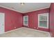 Simple bedroom with two windows and burgundy walls at 556 Peaceful Creek Dr, York, SC 29745