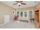 Bright bonus room with french doors and built-in shelving at 556 Peaceful Creek Dr, York, SC 29745