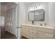 Bright bathroom with white vanity, arched mirror, and linen closet at 35 Old Post Rd, Clover, SC 29710