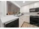 Clean and bright kitchen with white cabinets and black appliances at 35 Old Post Rd, Clover, SC 29710