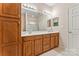 Double vanity bathroom with wood cabinets and a shower at 6801 Cinnamon Cir, Mint Hill, NC 28227