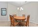 Round dining table with four chairs, chandelier, and mirror at 6801 Cinnamon Cir, Mint Hill, NC 28227