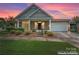 Brick front home with attached garage and manicured landscaping at 6801 Cinnamon Cir, Mint Hill, NC 28227