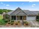 Brick and shingle home with screened porch and landscaping at 6801 Cinnamon Cir, Mint Hill, NC 28227