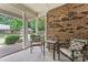 Relaxing screened porch with brick wall and comfortable seating at 6801 Cinnamon Cir, Mint Hill, NC 28227