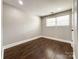 Well-lit bedroom featuring hardwood floors and a window at 4230 Northaven Dr, Charlotte, NC 28206