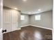 Hardwood floor bedroom with double-door closet and window at 4230 Northaven Dr, Charlotte, NC 28206