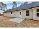 A concrete slab porch accents this backyard featuring a newly built home with white siding and a door at 6169 Long Branch Rd, Salisbury, NC 28147