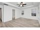 Bright bedroom features a ceiling fan, neutral walls, and wood-look flooring at 6169 Long Branch Rd, Salisbury, NC 28147