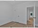 A bright bedroom features pristine white walls, an open doorway and an additional closet for organized storage at 6169 Long Branch Rd, Salisbury, NC 28147