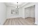 Inviting dining area with modern floors, white walls, and a stylish chandelier at 6169 Long Branch Rd, Salisbury, NC 28147