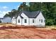 New construction with white siding, black roof, and green tree backdrop on a large lot is move-in ready at 6169 Long Branch Rd, Salisbury, NC 28147