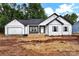 Charming single-story home with white siding, a gray roof, and an attached garage at 6169 Long Branch Rd, Salisbury, NC 28147