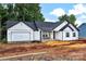 New construction with white siding, black roof, and front porch on a large lot is move-in ready at 6169 Long Branch Rd, Salisbury, NC 28147