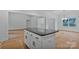 Modern kitchen island boasts a dark countertop and white cabinetry, offering style and functionality in a bright space at 6169 Long Branch Rd, Salisbury, NC 28147