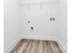 Functional laundry room with modern flooring, white walls, and convenient shelving at 6169 Long Branch Rd, Salisbury, NC 28147