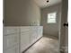 Clean bathroom featuring a modern vanity with white cabinets complemented by elegant countertops and natural light at 1500 Crowders Creek Rd, Gastonia, NC 28052