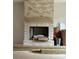 Charming brick fireplace with wooden mantel offering warmth and character to the living space, enhanced by natural light at 1500 Crowders Creek Rd, Gastonia, NC 28052