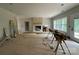 Bright living room with a striking brick fireplace, large window, and access to the outdoors, perfect for entertaining at 1500 Crowders Creek Rd, Gastonia, NC 28052