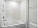 Bathroom with a white bathtub, white subway tile surround and chrome fixtures at 2024 Cedar Falls Dr # 9, Waxhaw, NC 28173