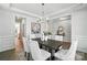 Beautiful dining area featuring a dark wood table with white chairs and a modern chandelier at 2024 Cedar Falls Dr # 9, Waxhaw, NC 28173